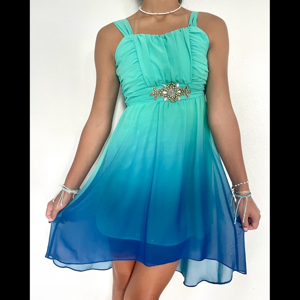 Flowy aqua-teal dress with jewel center and tie-back